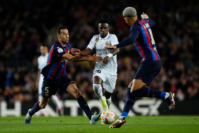 Sergio Busquets (left), Vinicius Junior (center) and Ronald Araujo (right) pictured in action during a Copa del Rey semi-final game between Barcelona and Real Madrid in April 2023